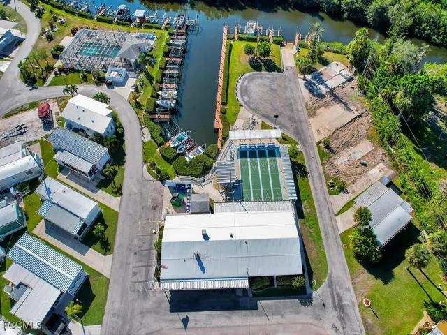 an aerial view of a house with a swimming pool and outdoor seating