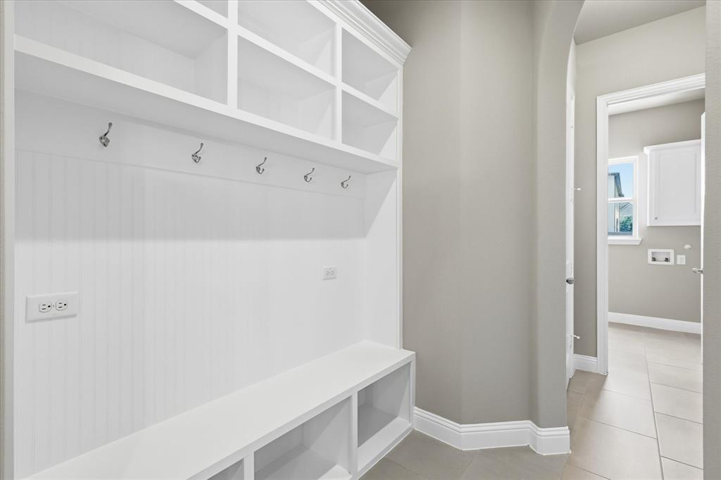 768 Huntingdon Street Coppell, TX 75019 - Photo 21 of 37 Practical built-in mudroom bench with cubbies, hooks, and upper storage — a perfect drop zone for bags, shoes, and everyday essentials.