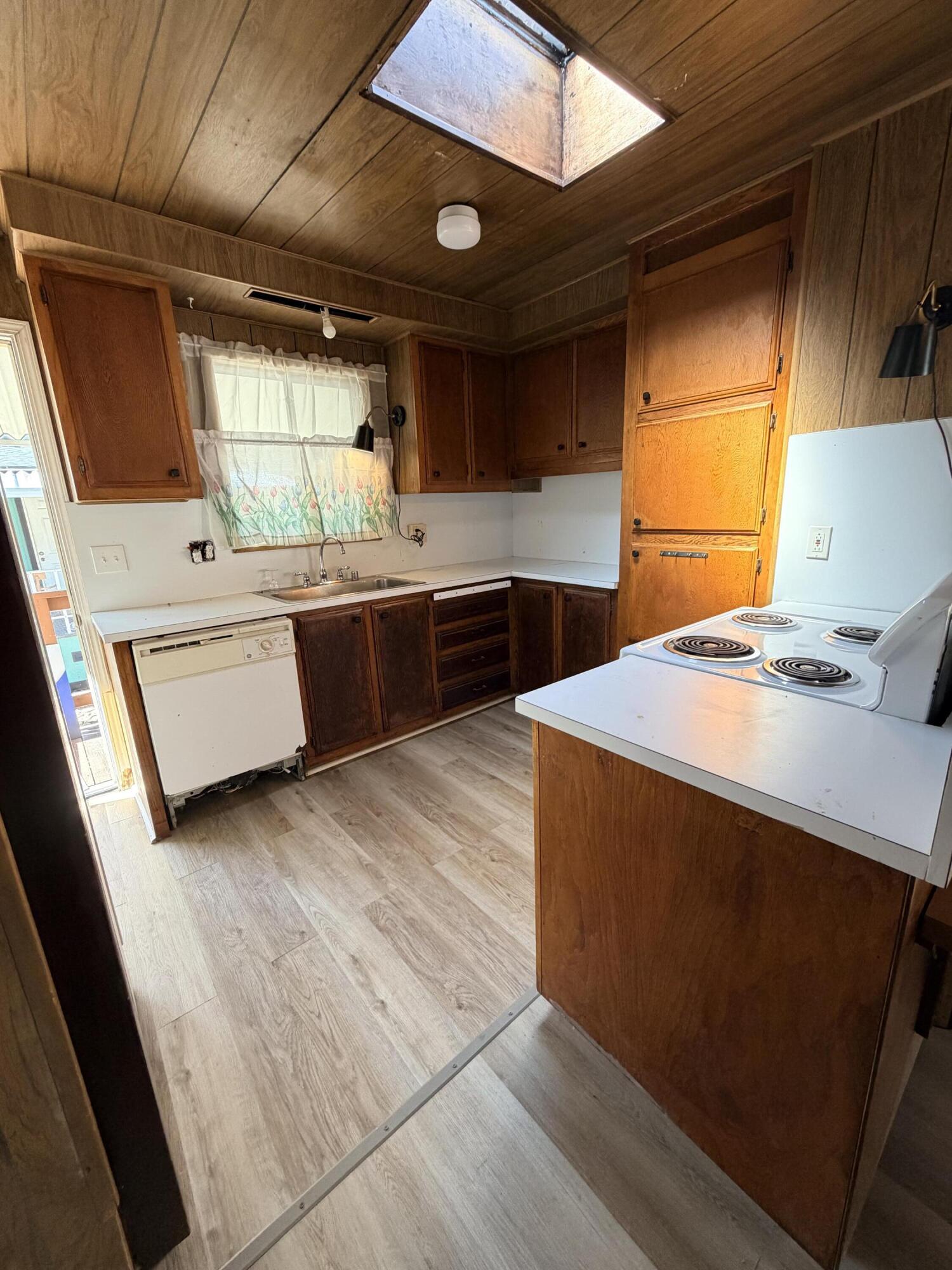 1449 Menomenee Lane, Unit 252 Redding, CA 96003 - Photo 8 of 18 a kitchen with stainless steel appliances kitchen island granite countertop a sink a stove a counter top space and cabinets