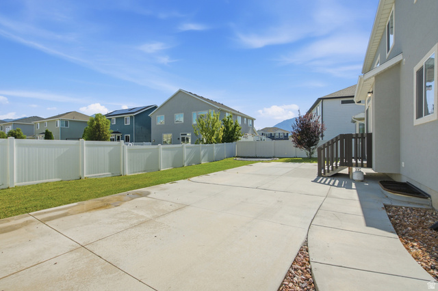 36 West Syracuse Road Vineyard, UT 84059 - Photo 46 of 56 Spacious concrete patio with an expansive lawn area