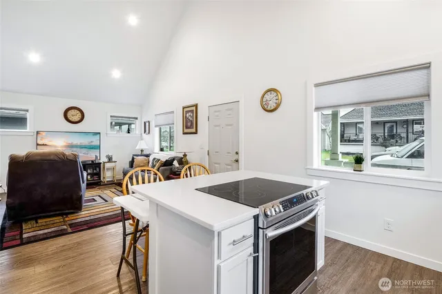 a open kitchen with stainless steel appliances granite countertop a stove and a refrigerator