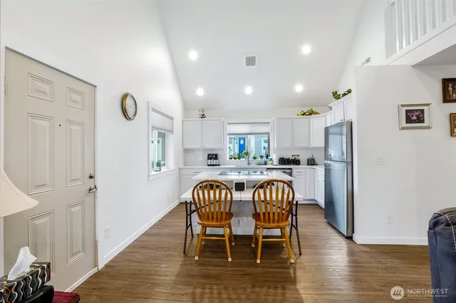 a view of a dining room with furniture and wooden floor