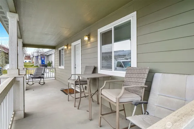 a dining room with furniture and a floor to ceiling window