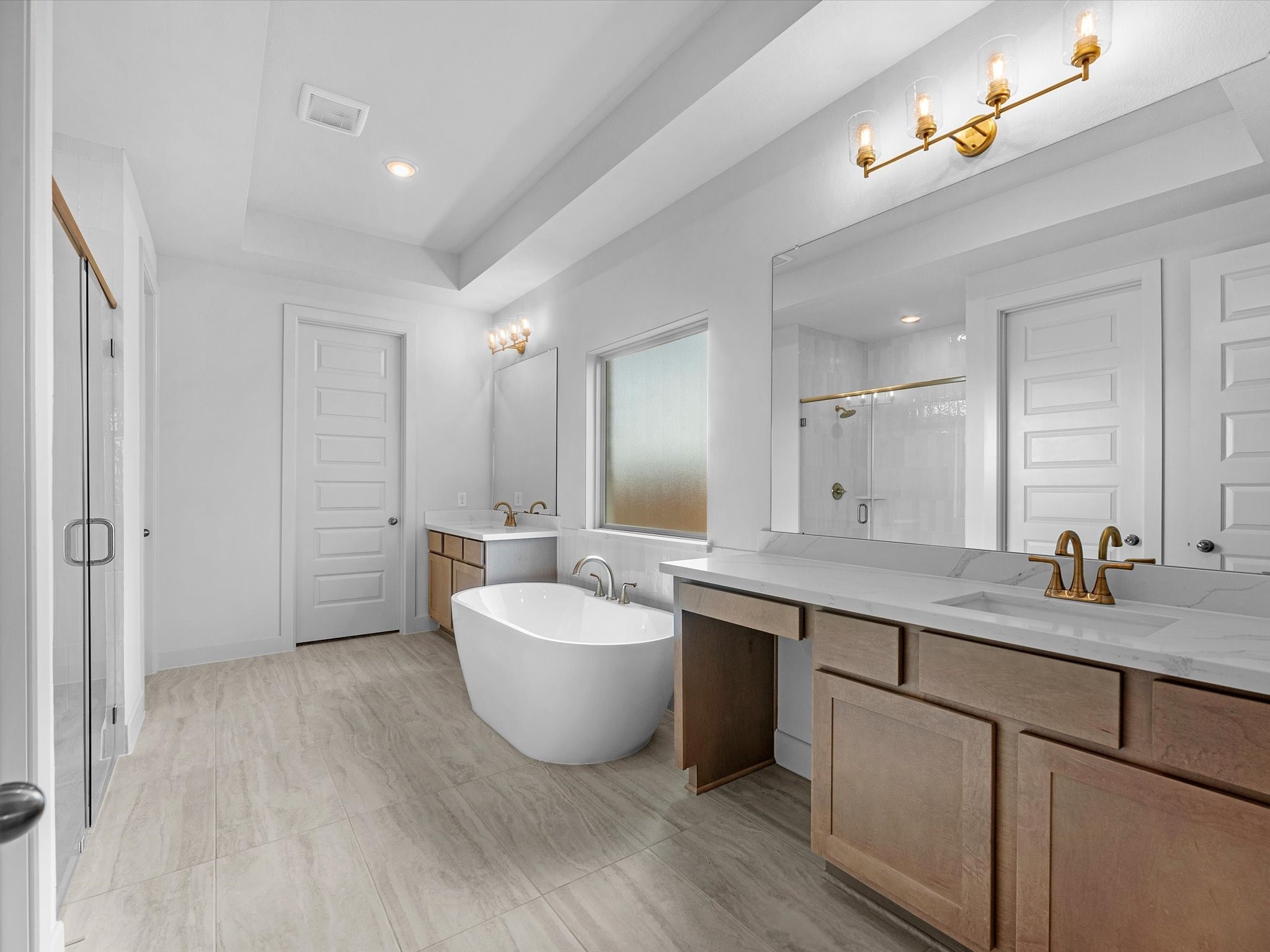 710 Walnut Br Drive Rosenberg, TX 77471 - Photo 12 of 25 a spacious bathroom with a double vanity sink a mirror and a bathtub