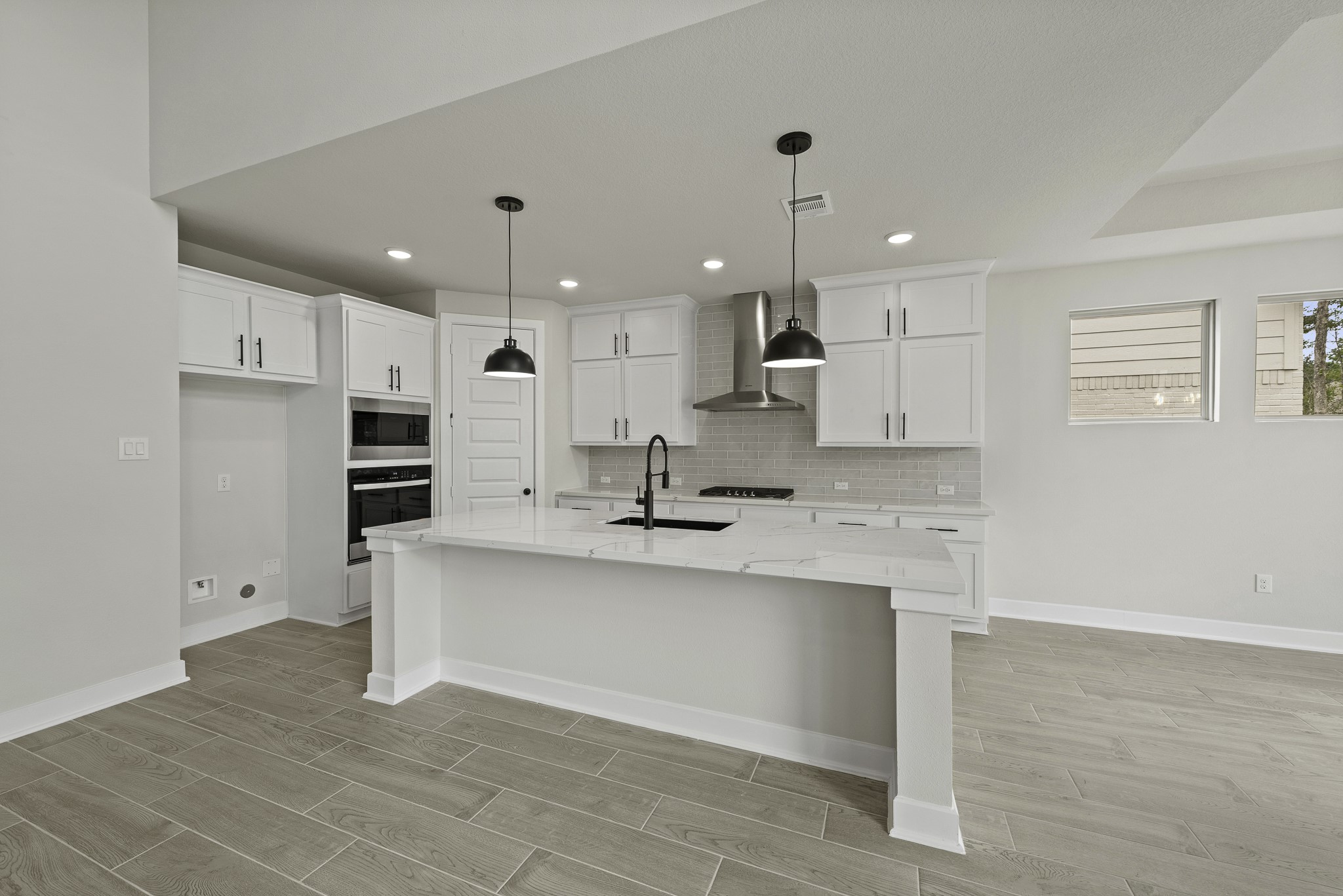 710 Walnut Br Drive Rosenberg, TX 77471 - Photo 6 of 24 a large white kitchen with kitchen island a sink a stove a refrigerator and white cabinets