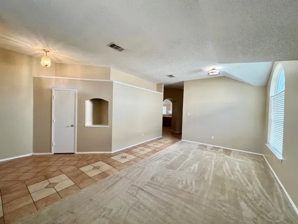 a view of a big room with wooden floor and windows