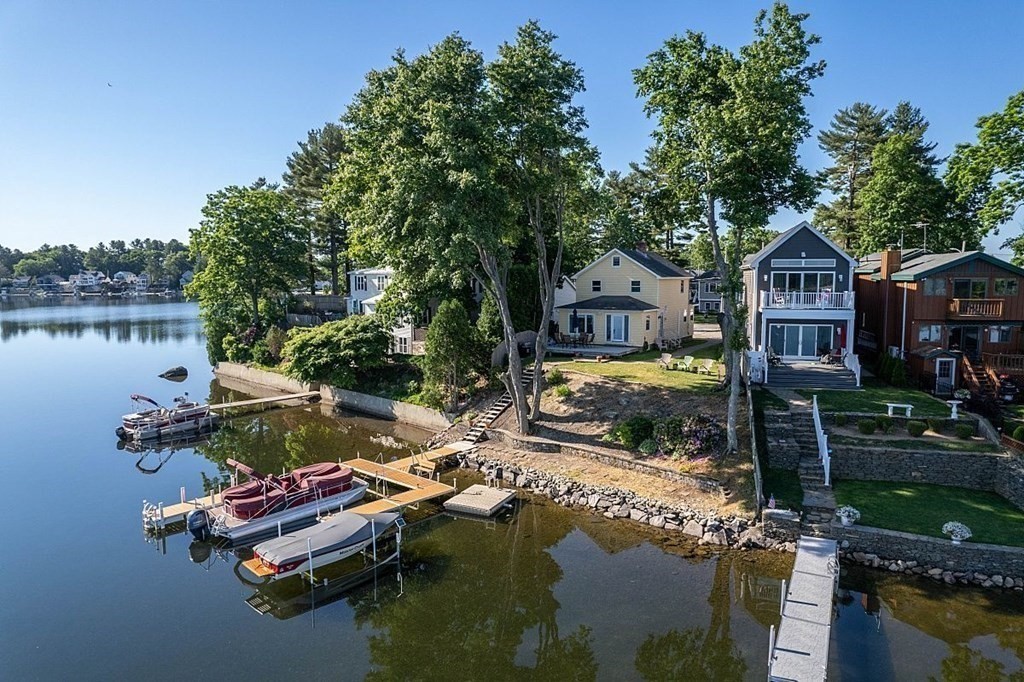 an aerial view of a house with swimming pool and outdoor seating
