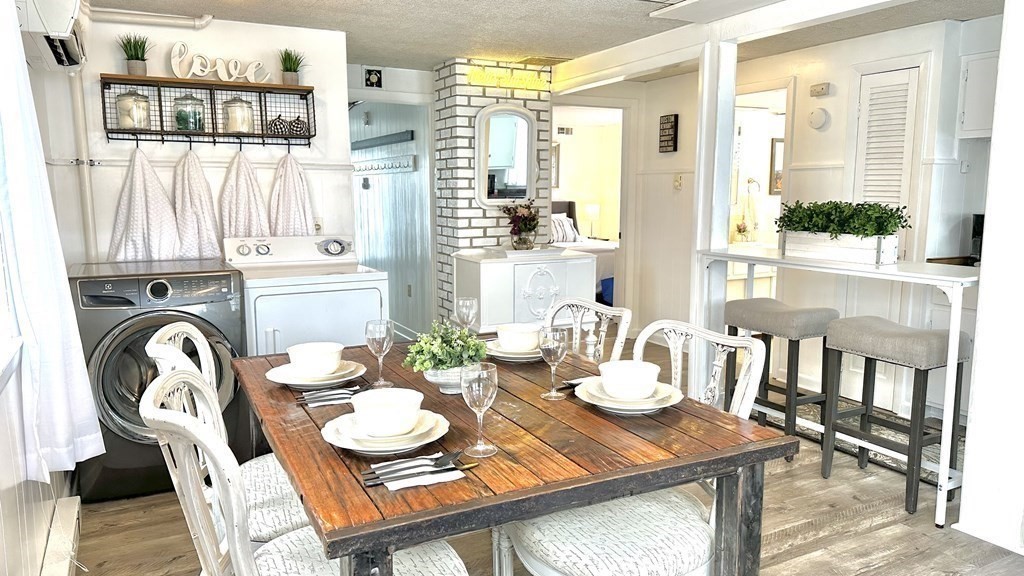 294 Killdeer Road Webster, MA 01570 - Photo 11 of 42 a view of a dining room with furniture large windows and wooden floor