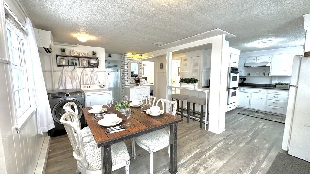 294 Killdeer Road Webster, MA 01570 - Photo 14 of 42 a view of a dining room and livingroom with furniture wooden floor and a rug