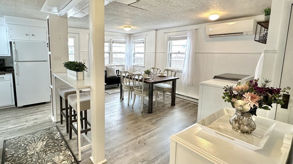 294 Killdeer Road Webster, MA 01570 - Photo 19 of 42 a living room with furniture dining table and a refrigerator