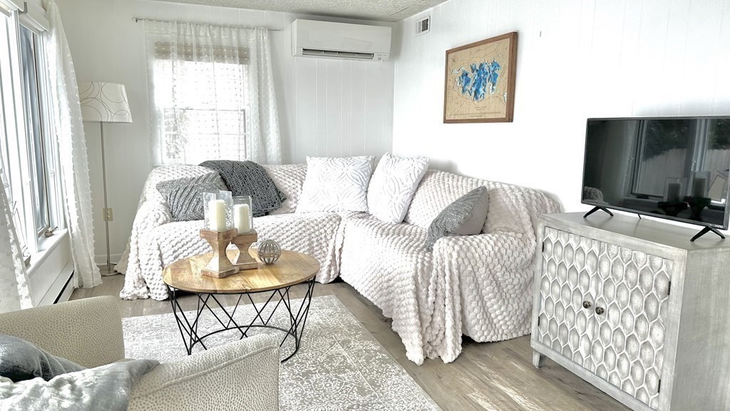 294 Killdeer Road Webster, MA 01570 - Photo 21 of 42 a living room with furniture and a flat screen tv