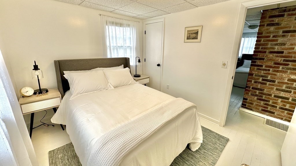 294 Killdeer Road Webster, MA 01570 - Photo 23 of 42 a bedroom with a bed and wooden floor