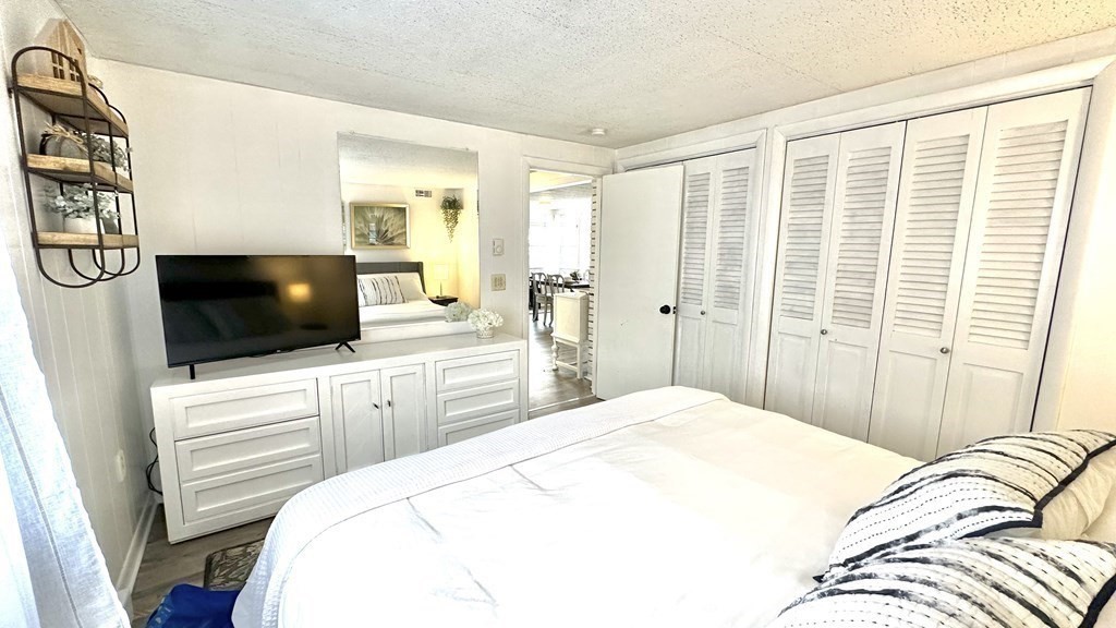 294 Killdeer Road Webster, MA 01570 - Photo 26 of 42 a bedroom with a large bed and a flat screen tv