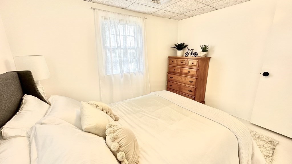 294 Killdeer Road Webster, MA 01570 - Photo 29 of 42 a bedroom with a bed and dresser with mirror