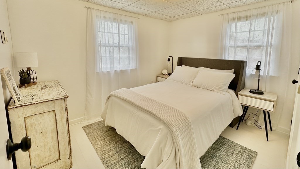 294 Killdeer Road Webster, MA 01570 - Photo 32 of 42 a bedroom with a bed and wooden floor