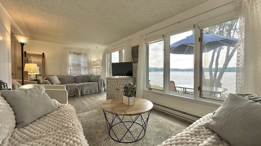 294 Killdeer Road Webster, MA 01570 - Photo 41 of 42 a living room with furniture and a large window
