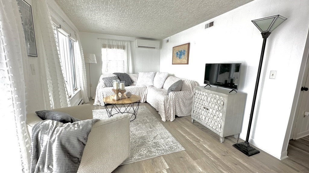 294 Killdeer Road Webster, MA 01570 - Photo 10 of 42 a living room with furniture and a flat screen tv