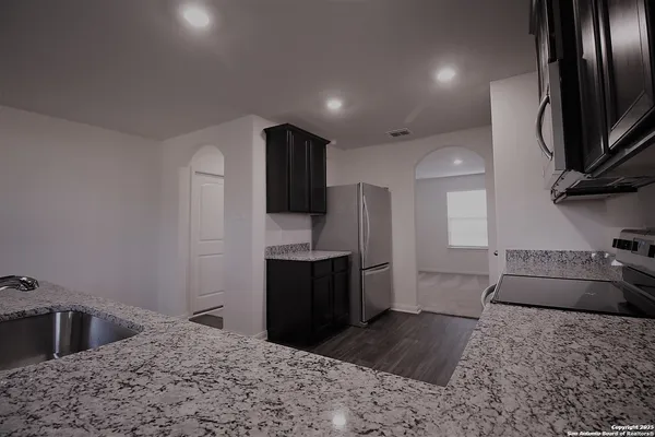 a kitchen with a refrigerator sink and stove