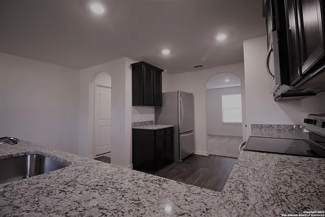 a kitchen with a refrigerator sink and stove