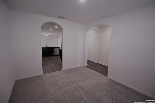 a view of an empty room with a kitchen