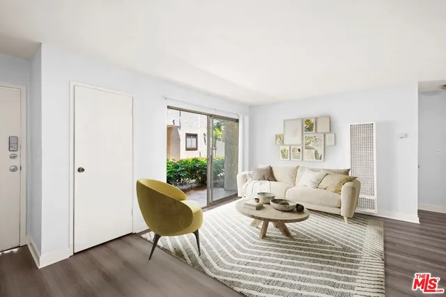 a view of a dining room with furniture and a potted plant