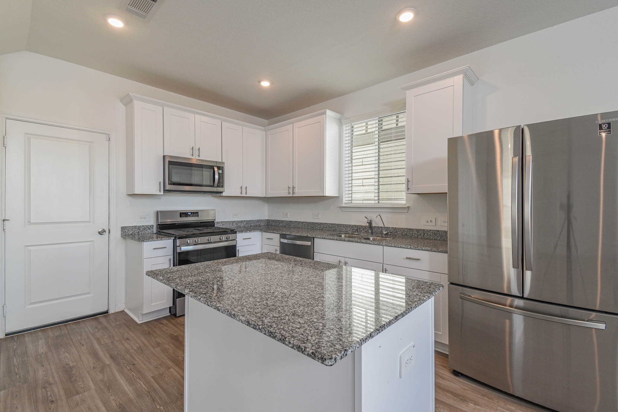 5727 Finely Run Street Spring, TX 77373 - Photo 5 of 26 a kitchen with stainless steel appliances granite countertop a refrigerator sink and microwave