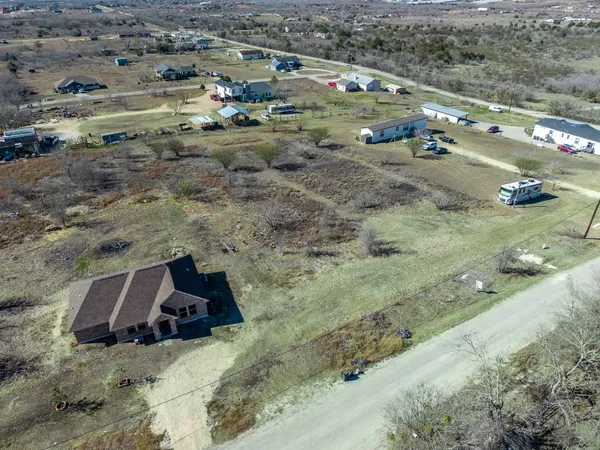 an aerial view of a residential houses with outdoor space
