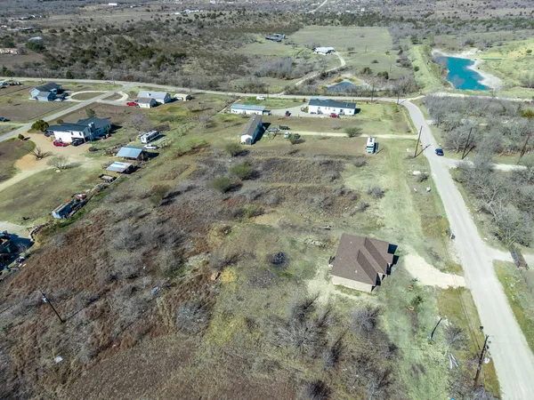 an aerial view of a house with a mountain