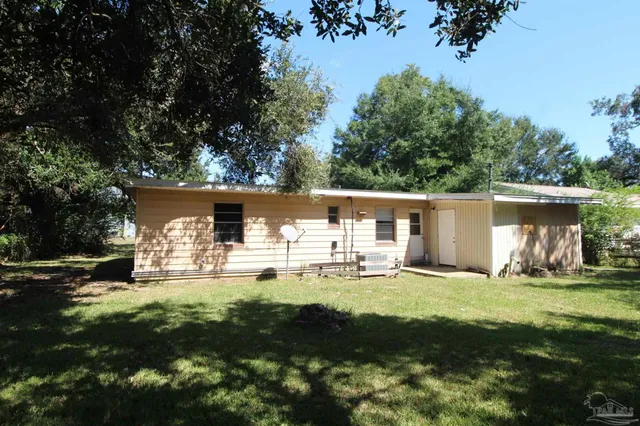 a house view with a sitting space and garden