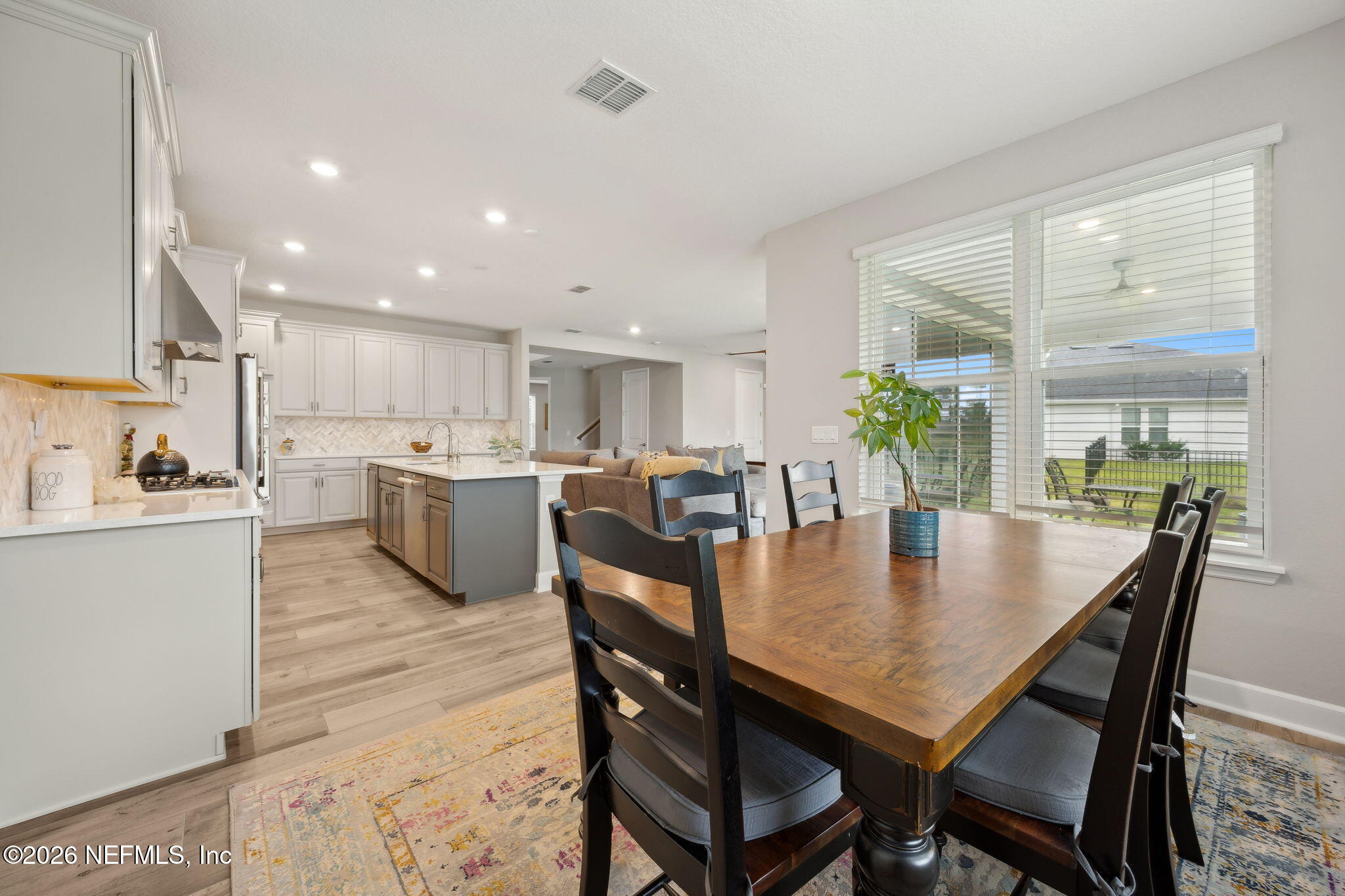 92503 Shipton Lane Fernandina Beach, FL 32034 - Photo 15 of 32 a view of a dining room with furniture and wooden floor