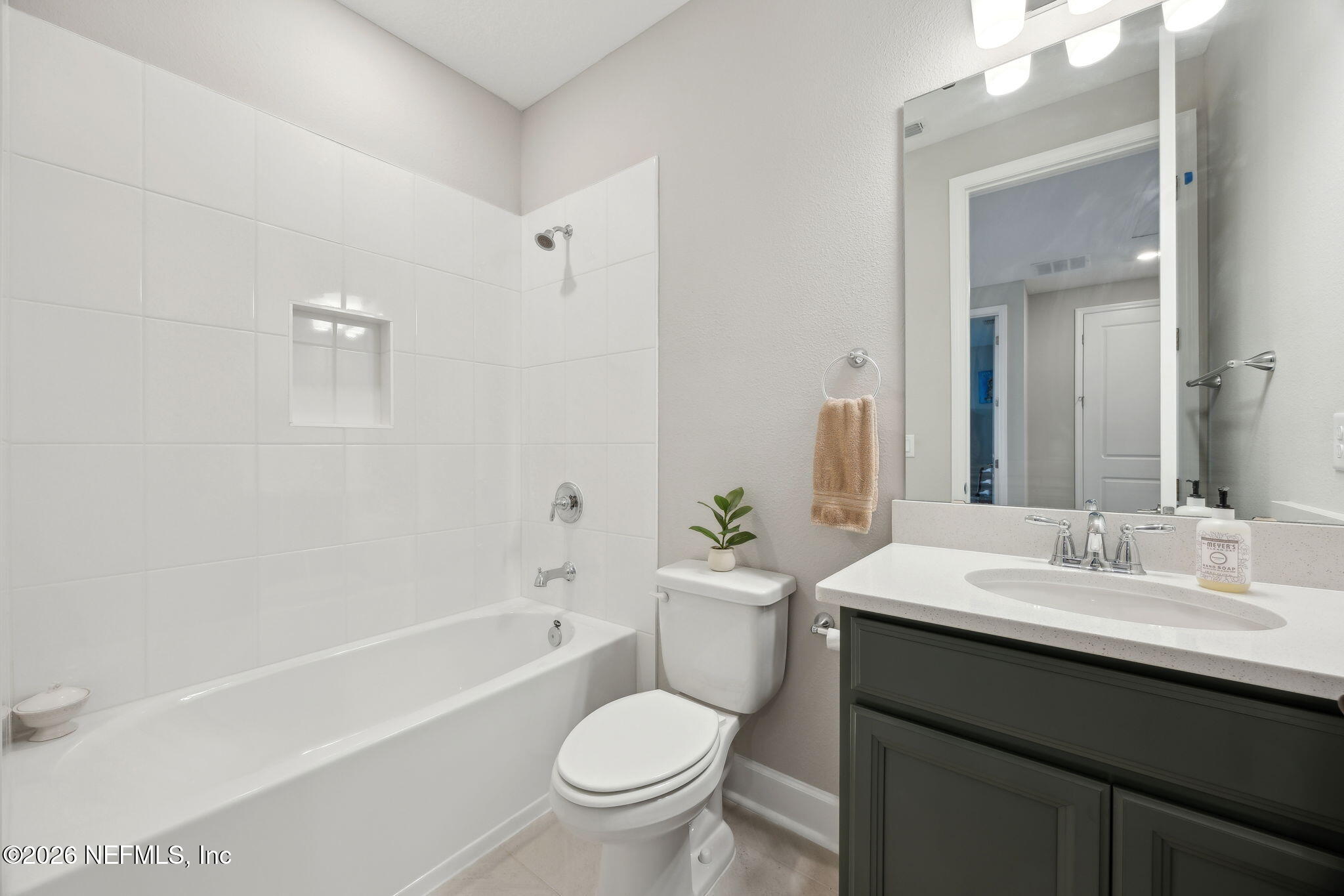 92503 Shipton Lane Fernandina Beach, FL 32034 - Photo 24 of 32 a bathroom with a granite countertop toilet a sink and a bathtub