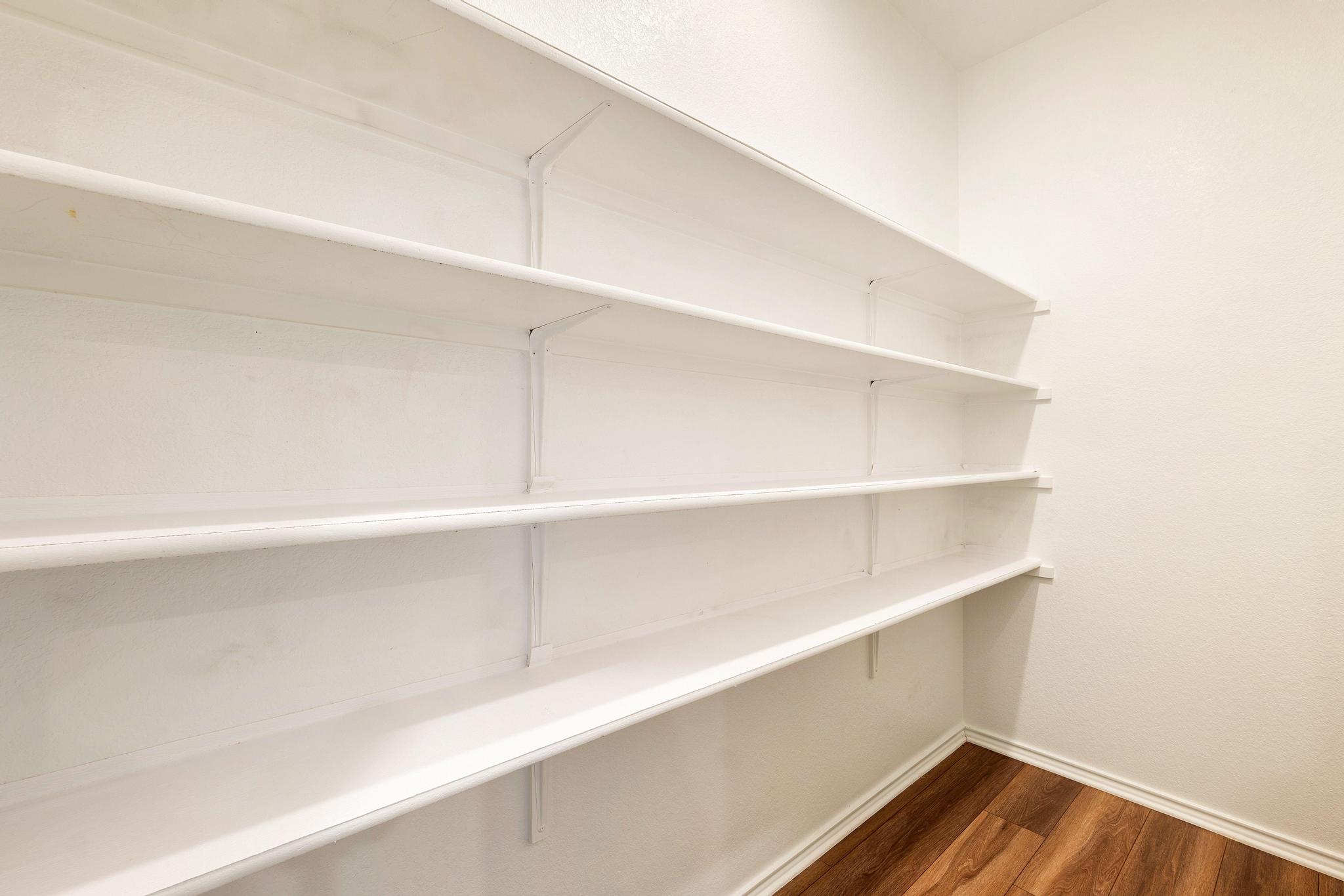 217 Innisfree Road Jarrell, TX 76537 - Photo 16 of 39 Ample storage space with extensive shelving in this functional pantry.