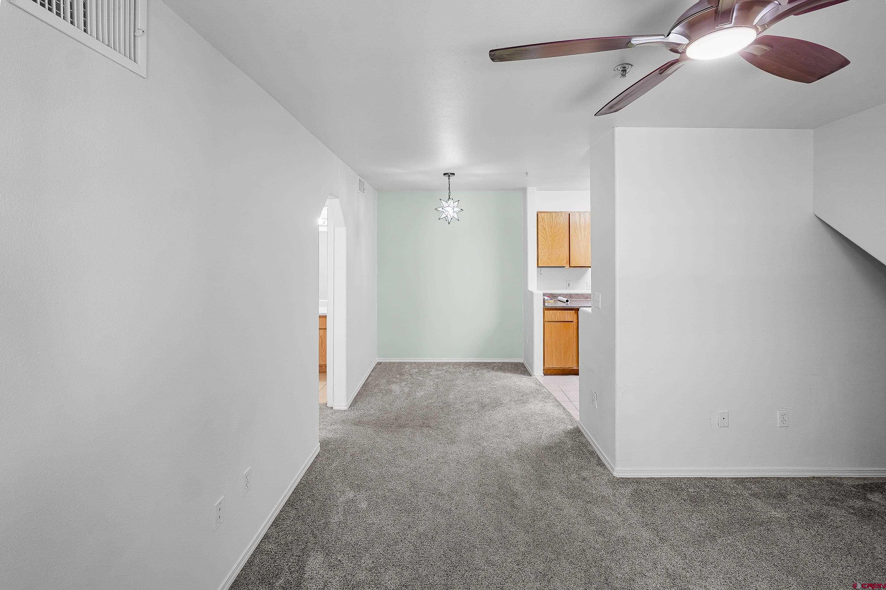 1100 Goeglein Gulch Road, Unit 163 Durango, CO 81301 - Photo 10 of 23 an empty room with wooden floor and windows