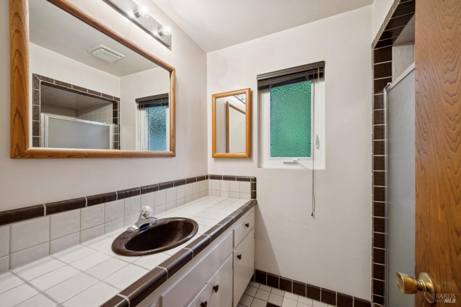 6 Madrona Street San Rafael, CA 94901 - Photo 28 of 47 a bathroom with a sink and a mirror