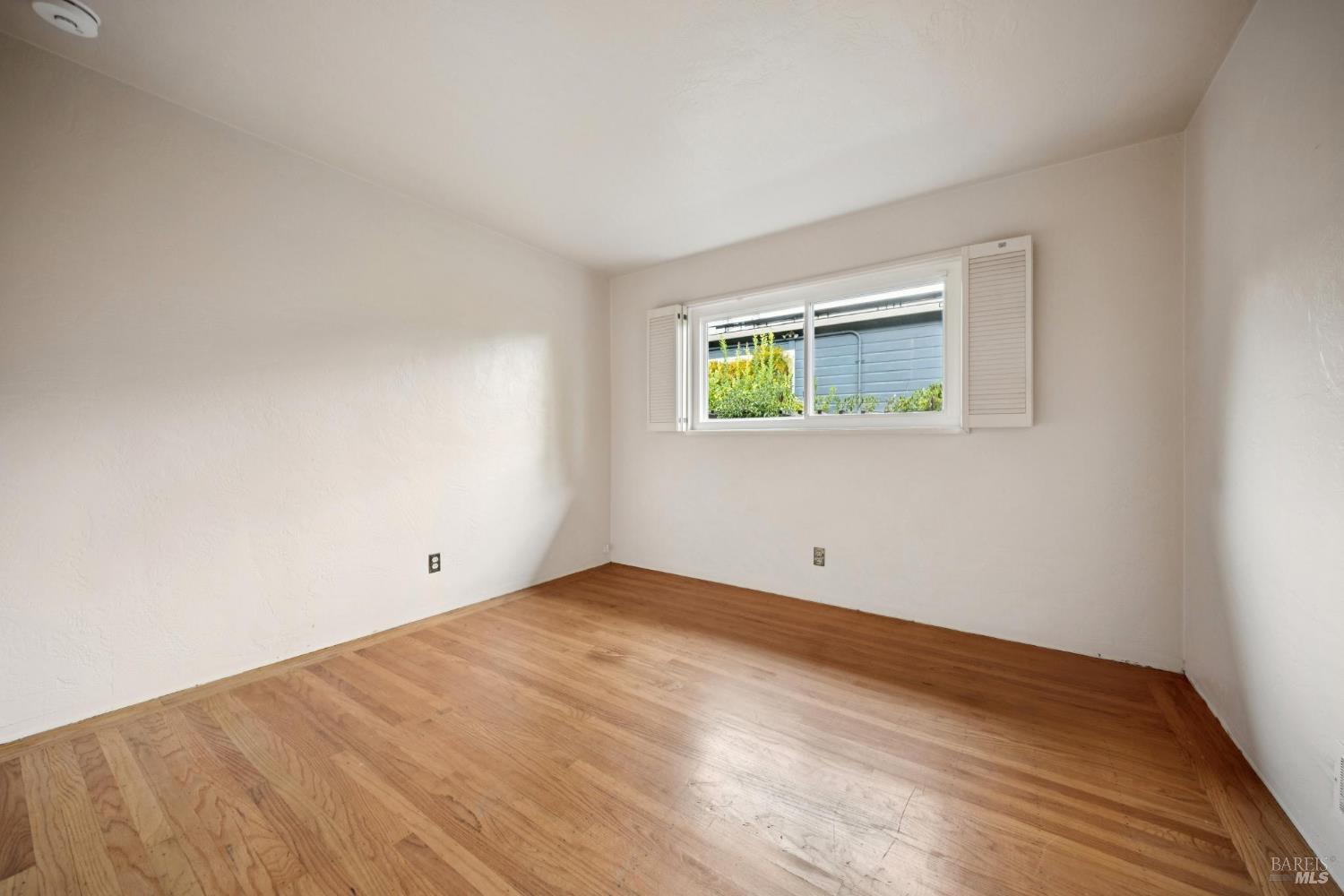 6 Madrona Street San Rafael, CA 94901 - Photo 30 of 47 a view of an empty room with a window and wooden floor