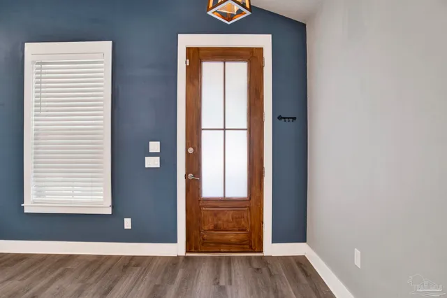 an empty room with windows and closet