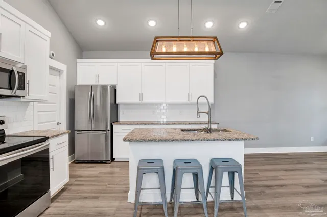 a kitchen with cabinets and stainless steel appliances