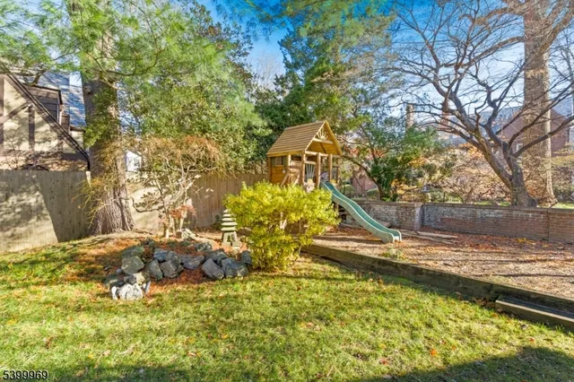 a view of backyard with wooden fence