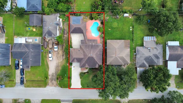 an aerial view of residential houses with outdoor space and lake view