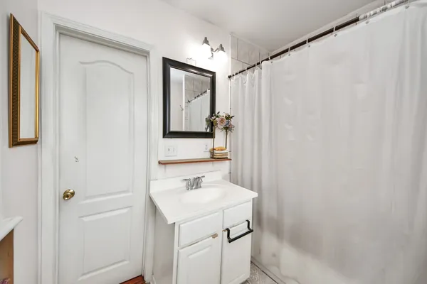 a bathroom with a sink a vanity and a mirror