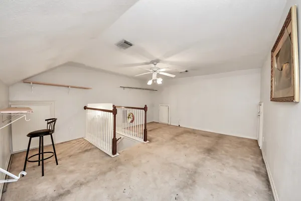 a view of an empty room with window and stairs