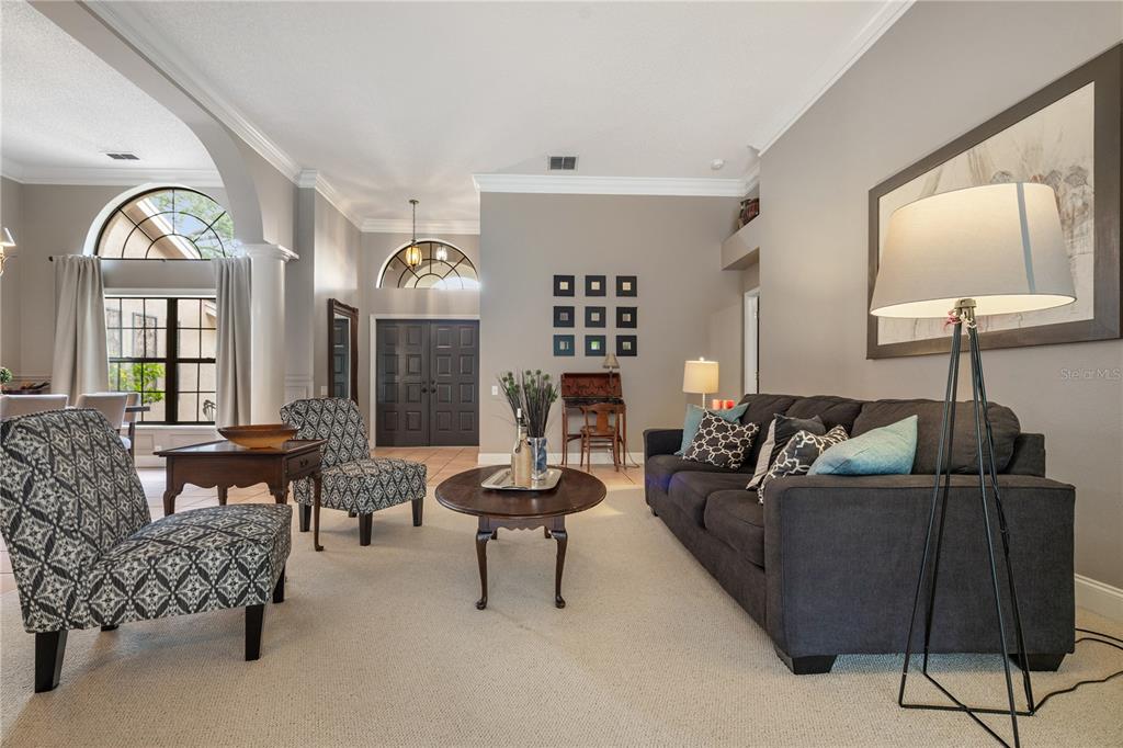 3372 Brian Road South Palm Harbor, FL 34685 - Photo 8 of 45 a living room with furniture and a large mirror next to a window