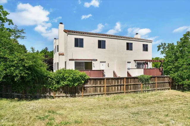 a view of a white house with a yard