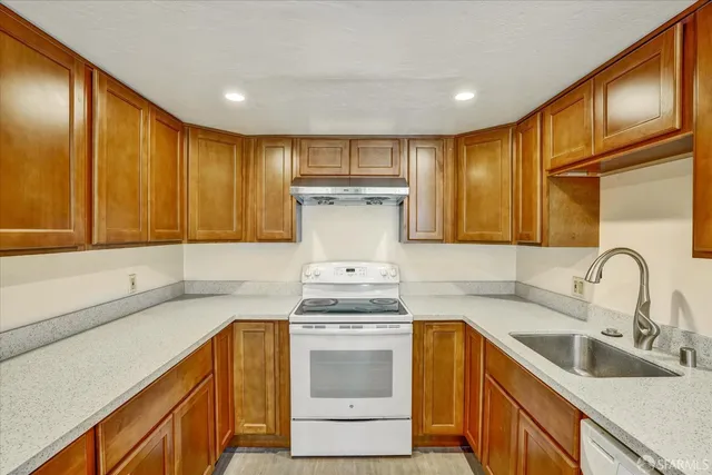 a kitchen with a sink stove and cabinets
