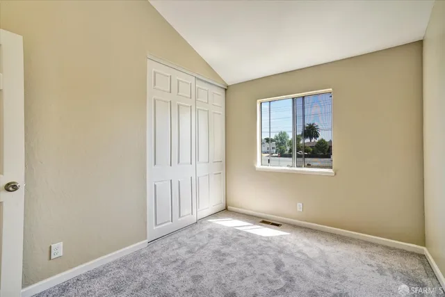 an empty room with large windows