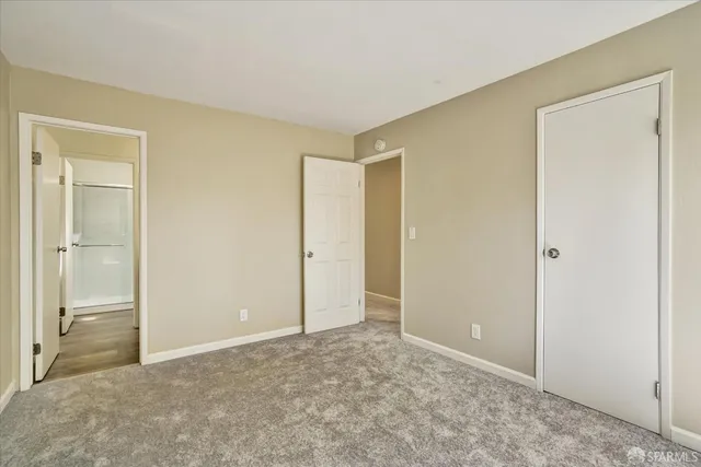 a view of a livingroom with an empty space and a window