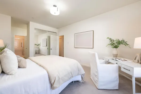 a bedroom with a bed and a table