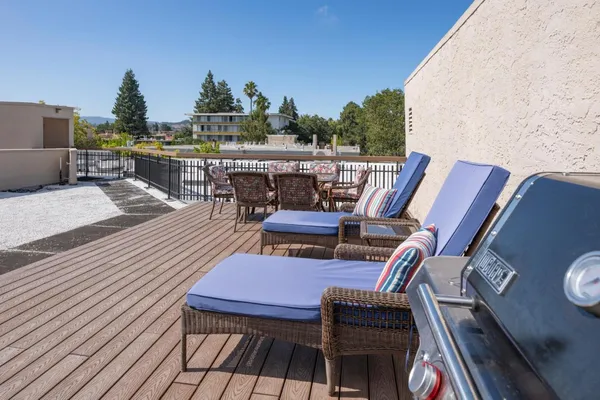 a view of a balcony with wooden floor outdoor seating