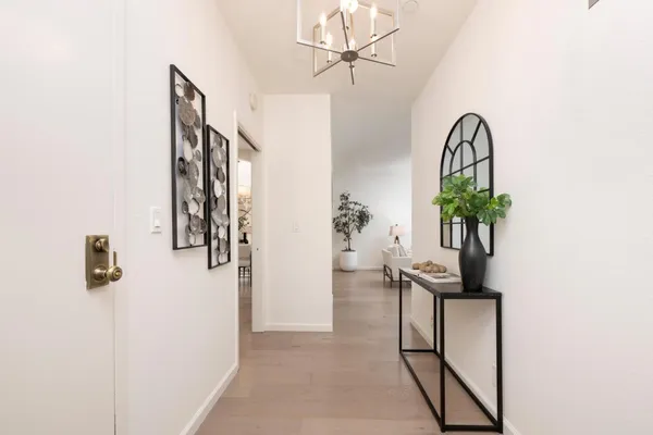 a view of entryway with paintings on the wall