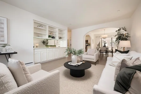 a living room with furniture and a potted plant